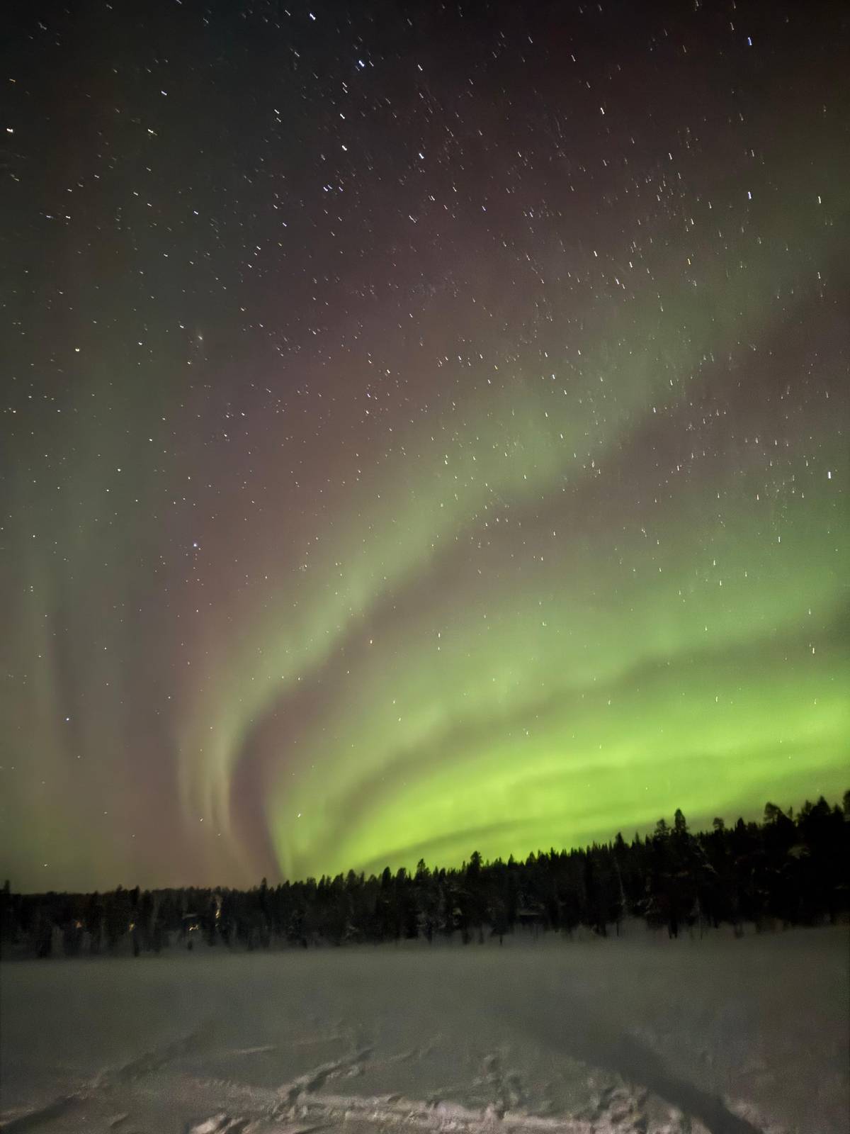 Aurora spreading over a frozen lake