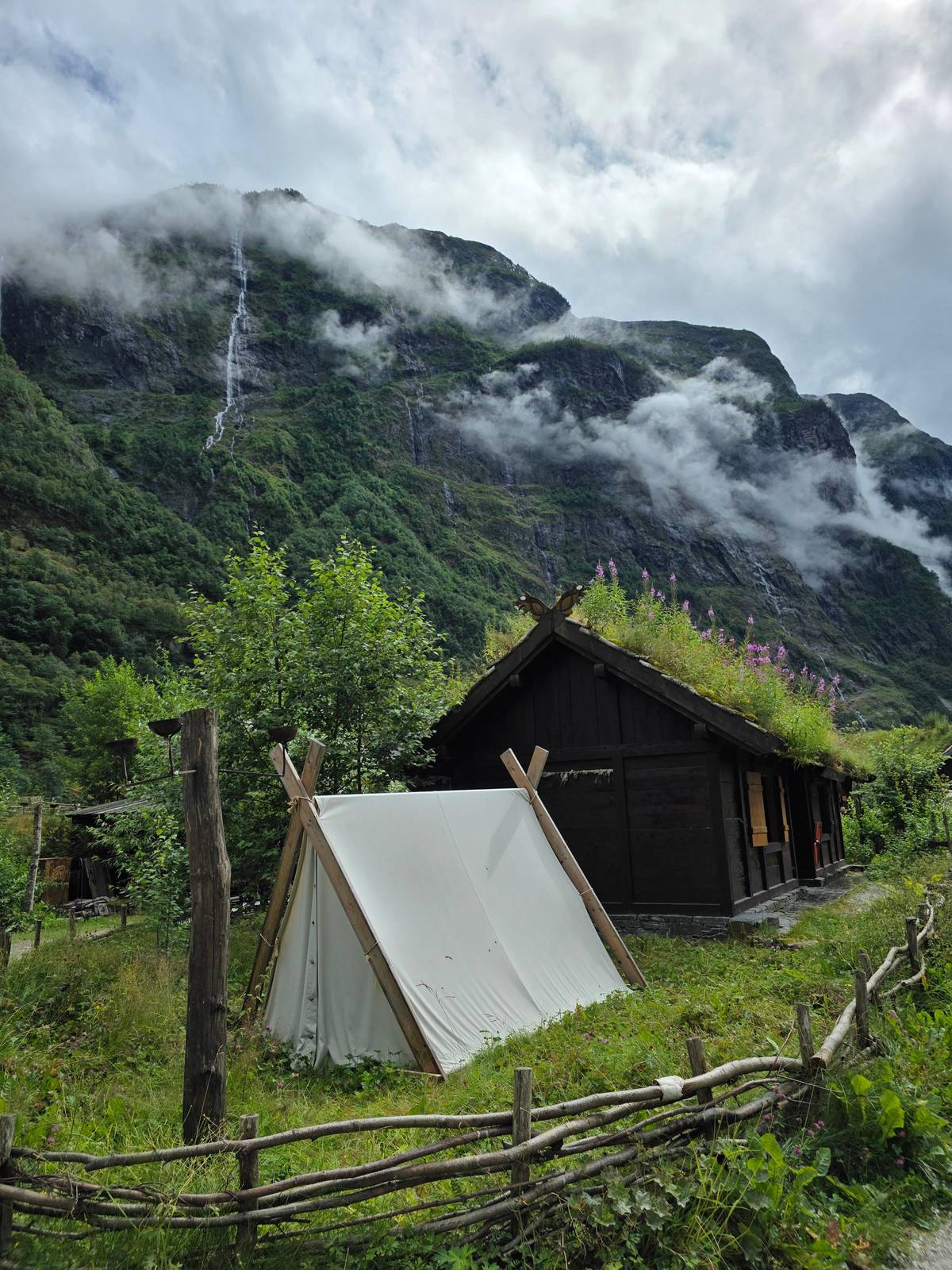 A turf-roofed hut and a canvas tent in the Viking village