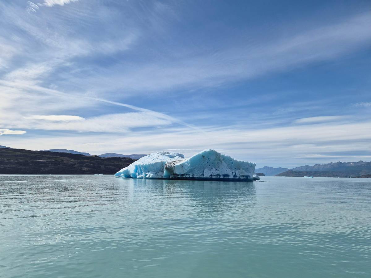 A blue iceberg on open water