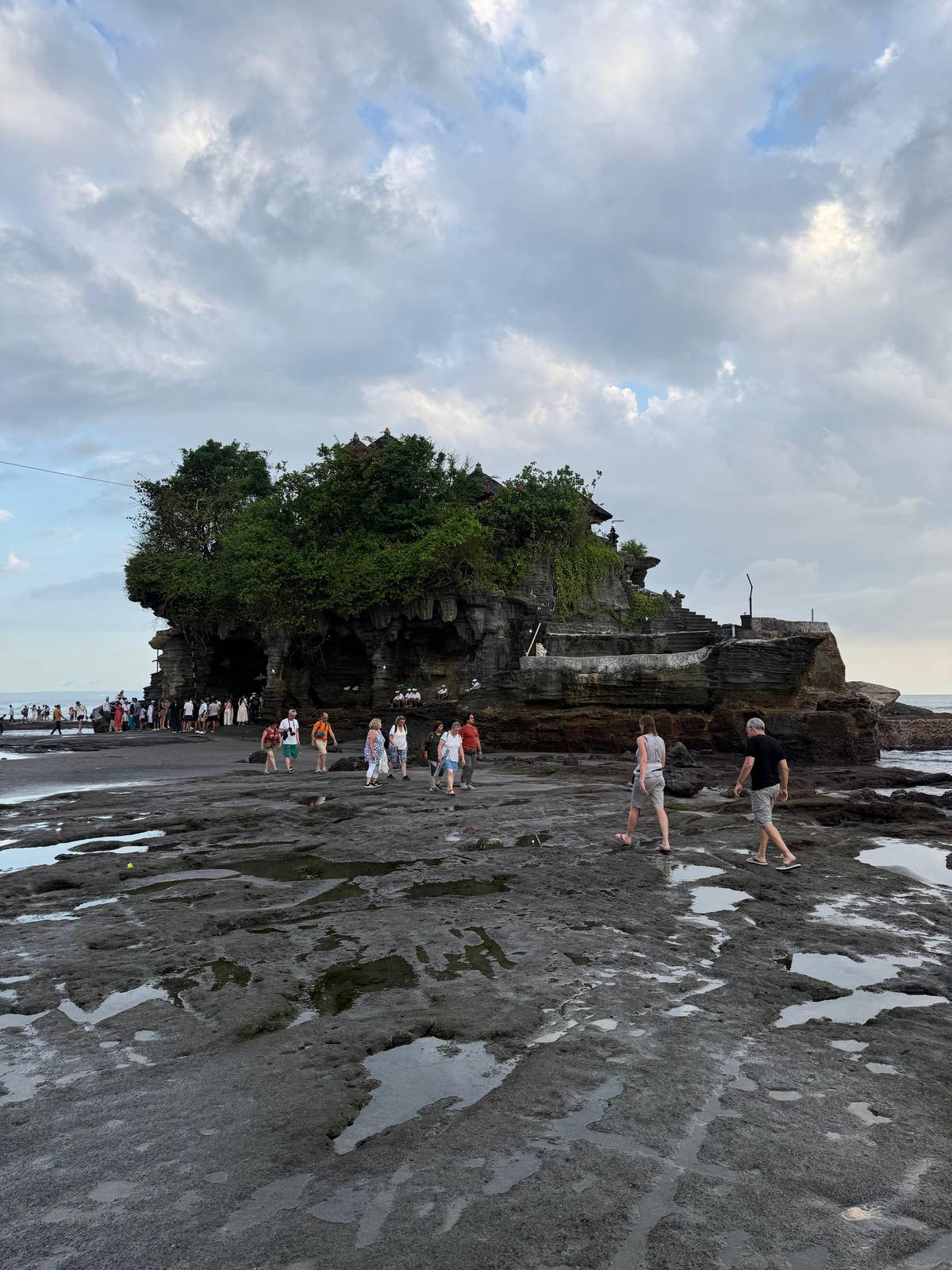 Visitors crossing the reef to Tanah Lot at low tide