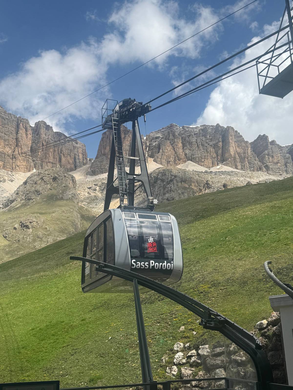 A cable car cabin below the Sella walls