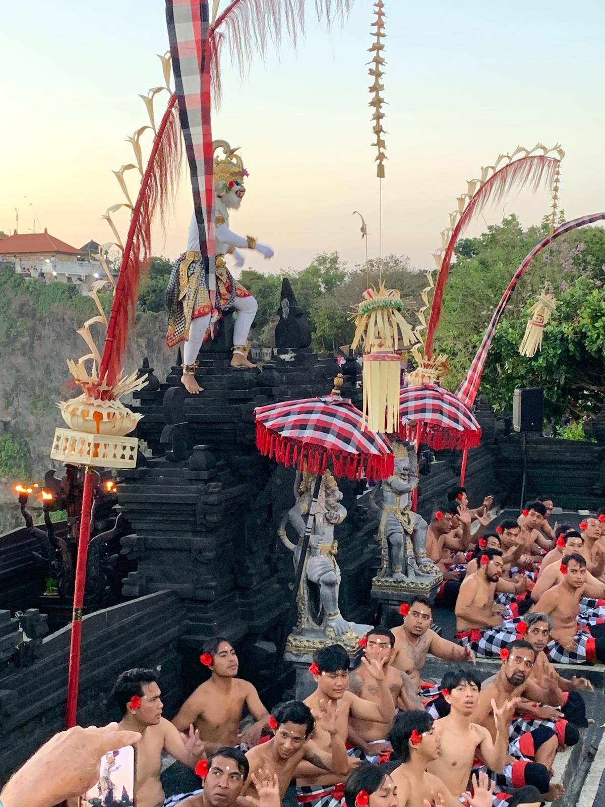 Hanoman on the stone wall among tall bamboo poles