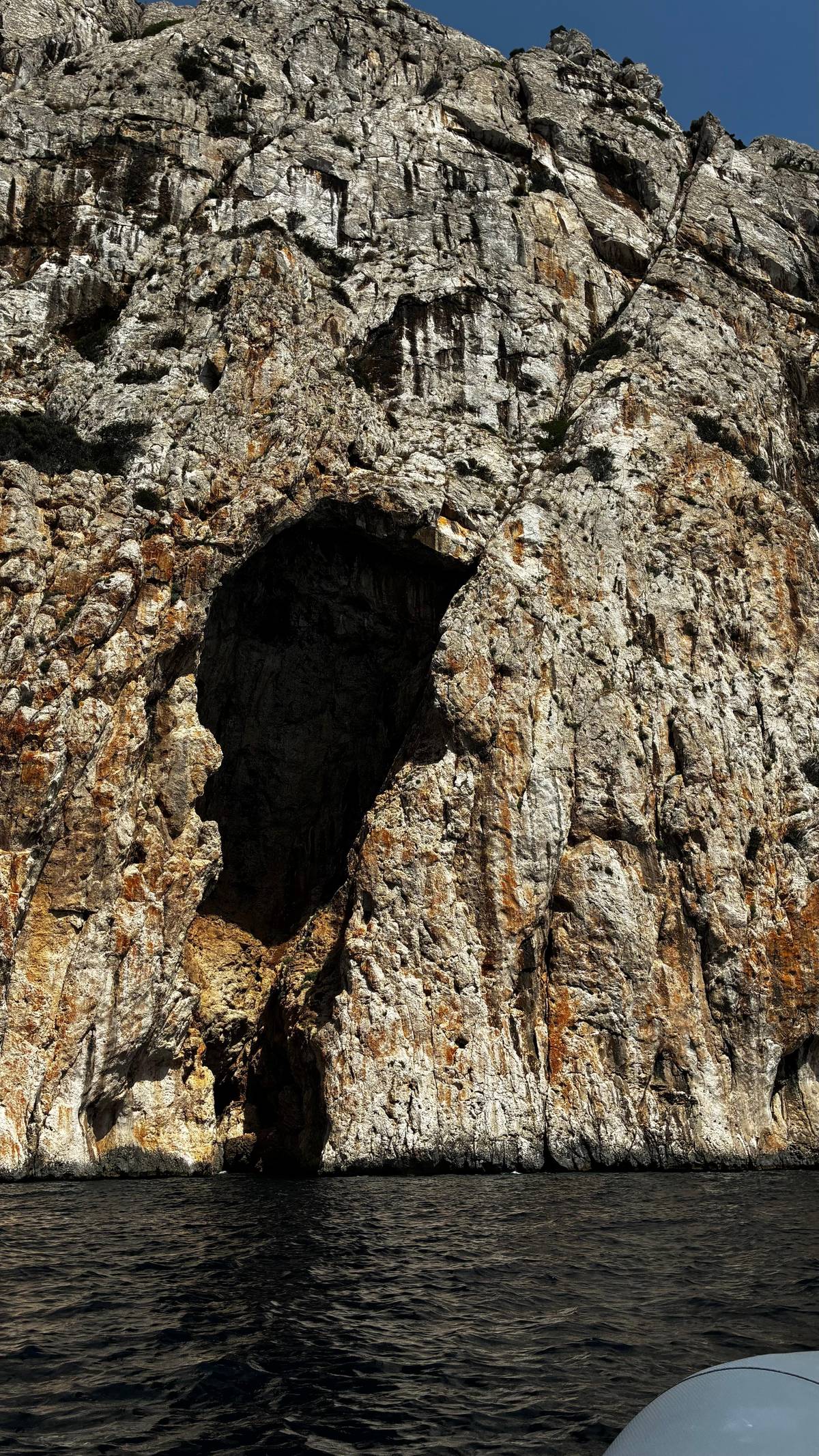 A cave in the limestone at the waterline