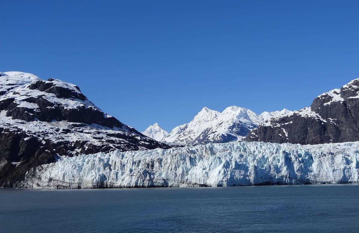 A glacier front under a clear sky