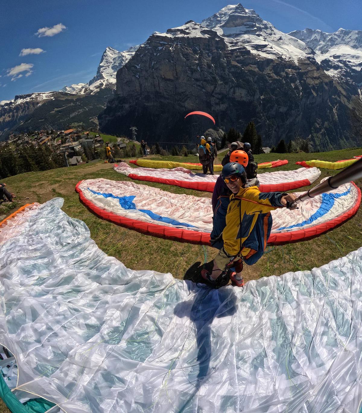 Gliders spread on the take-off with the peaks behind