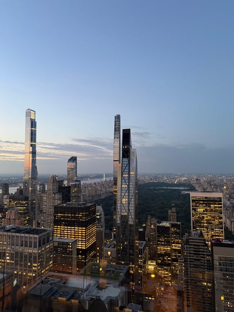 Dusk across the Central Park South supertalls, windows warming along Billionaires' Row