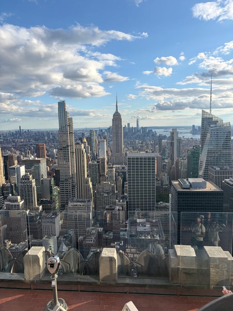 One of the deck's fixed viewing telescopes on the terrace, Midtown and the Empire State Building behind it