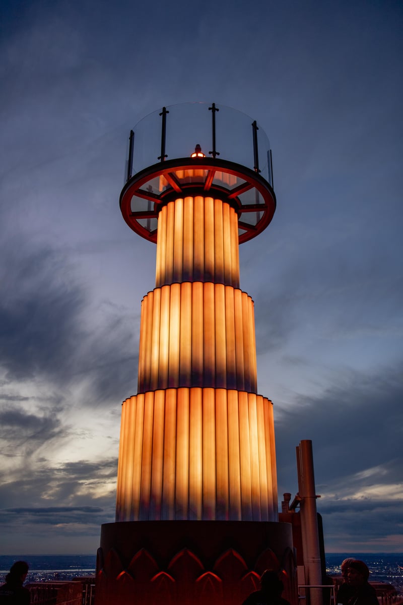 The SKYLIFT platform lit orange against a dusk sky above the 70th floor