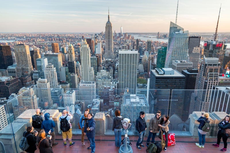 Visitors along one of the glass-screened lower terraces, where you retreat when the wind comes off the Hudson