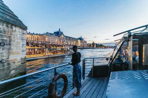 Dinner cruise on the Seine River with illuminated Paris skyline