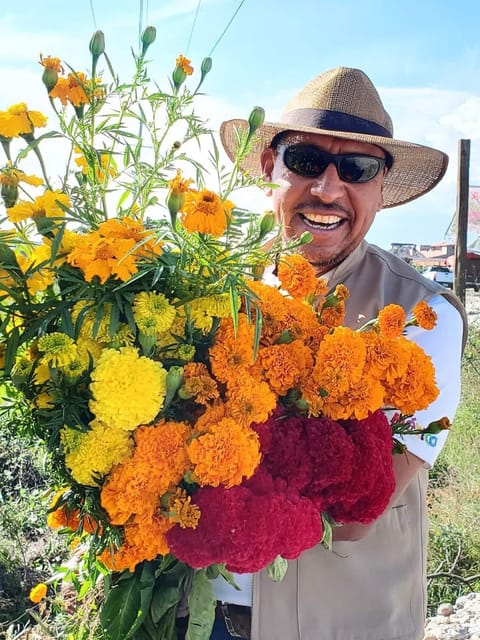 Marigold petals, candles and family photographs arranged on an Oaxaca altar