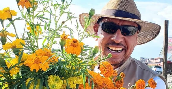 Marigold petals, candles and family photographs arranged on an Oaxaca altar