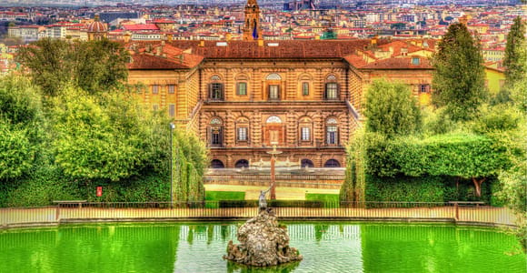 The broad stone façade of Pitti Palace seen across its sloping courtyard