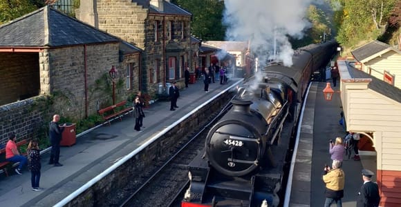 Steam train crossing open moorland on the route towards Whitby