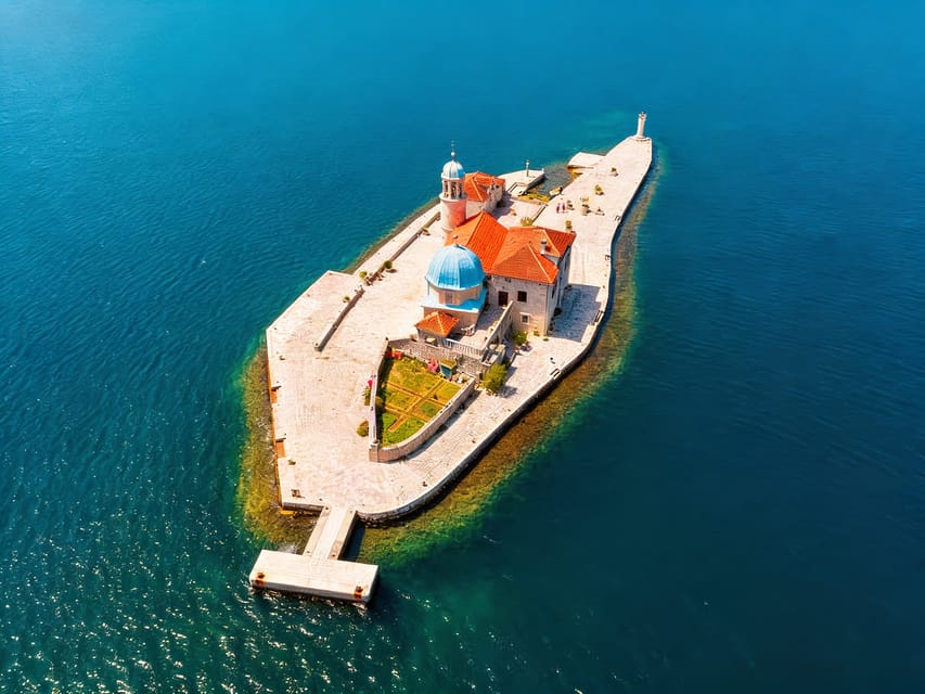 The stone waterfront of Perast facing two small islands in the Bay of Kotor