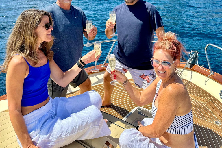 Capri Boat Tour with Caves, Swimming, Aperitif and Champagne From Capri: PRIVATE Capri Boat Tour