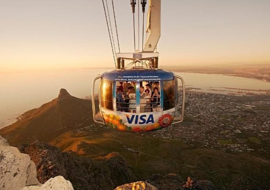 Tour minibus at a viewpoint on the Cape Peninsula with Table Mountain in the distance