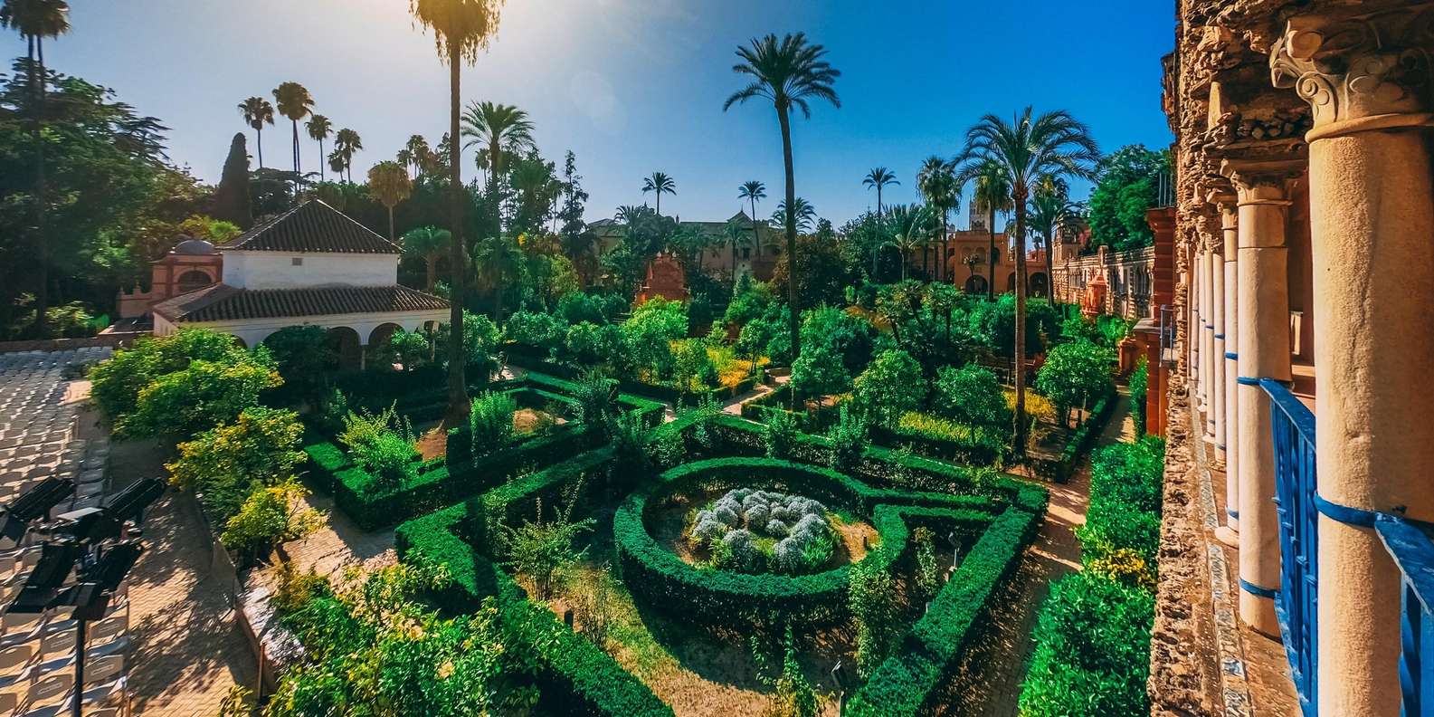 Royal Alcázar Seville guided tour — licensed guide and small group walking between Moorish horseshoe arches
