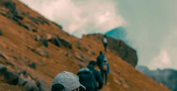 Hikers climbing a rocky mountain slope