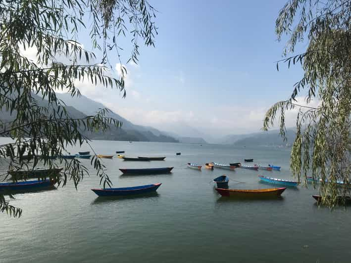 A paraglider nears the landing zone above Phewa lake in Nepal