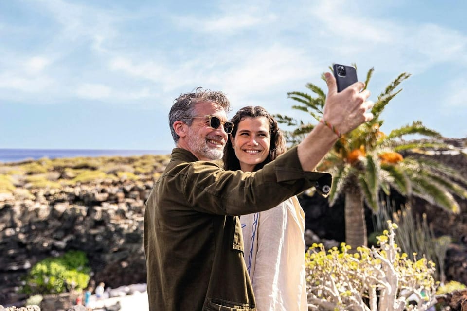 Visitors photographing themselves on the coastal terrace of a Manrique visitor centre
