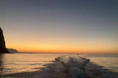 Aperitif on a boat at sunset at the Grotta della Regina