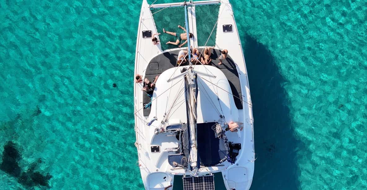 From Ornos: Mykonos Delos Catamaran Cruise with Meal & SUP — a boat tour from Mykonos, Greece