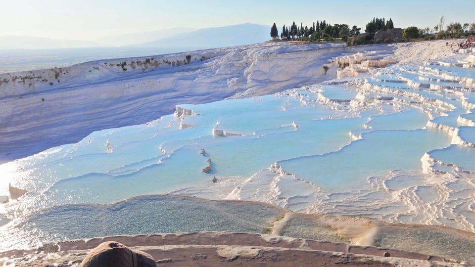 White travertine terraces descending below the ruins of Hierapolis