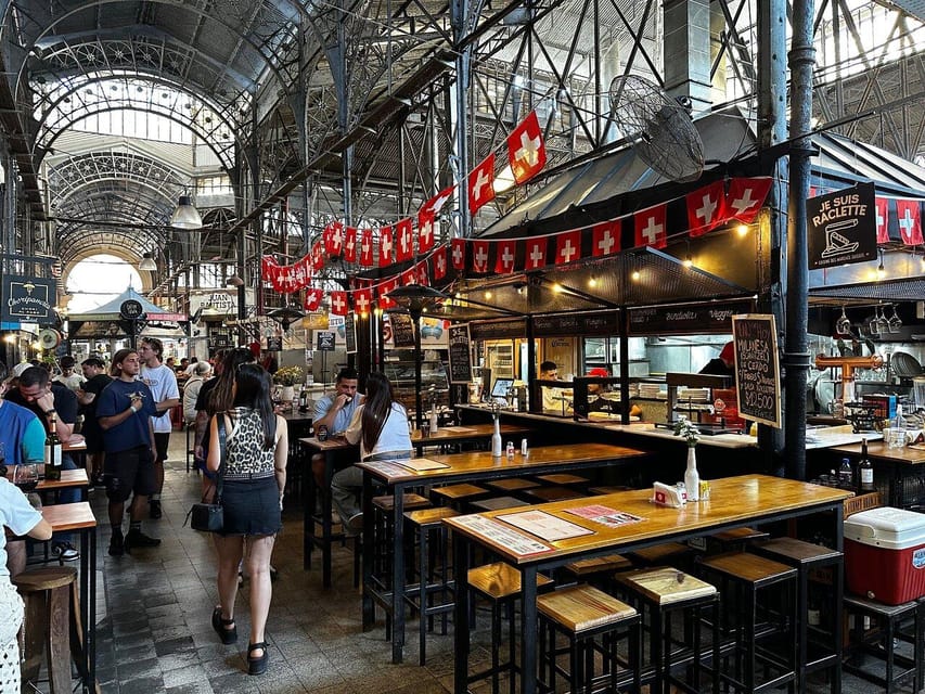 Antique stalls and pedestrians beneath old façades in San Telmo