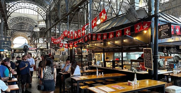 Antique stalls and pedestrians beneath old façades in San Telmo