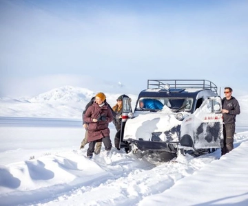 Jotunheimen: Snowcoach Tour with Snowhoeing and Lunch