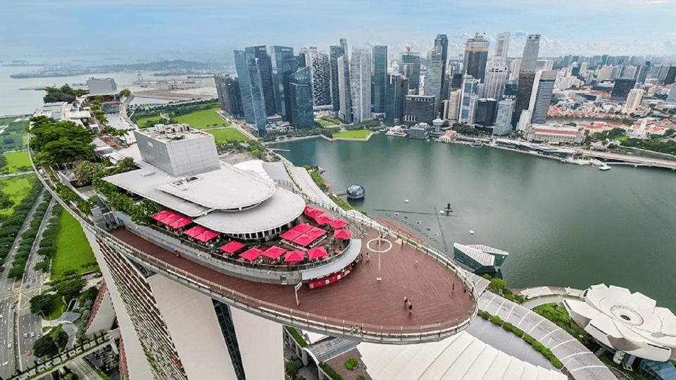The curved roof terrace on top of Marina Bay Sands, looking out over the bay towards the towers of the financial district