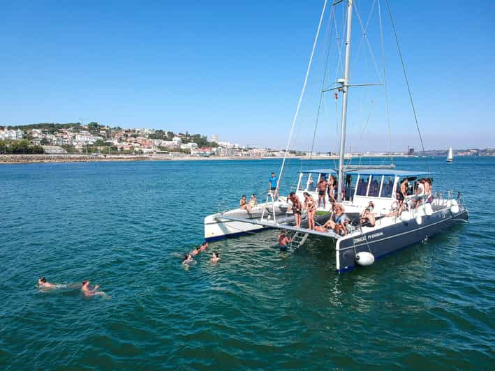 Lisbon: Catamaran Boat Party with Music, Open Bar & Swimming | GetYourGuide