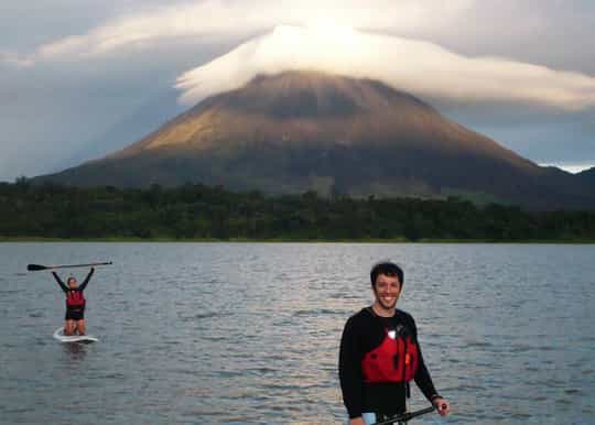 standup paddle crossing on lake arenal