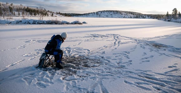 From Ivalo: Arctic Ice Fishing & Open-Fire Cooking Tour