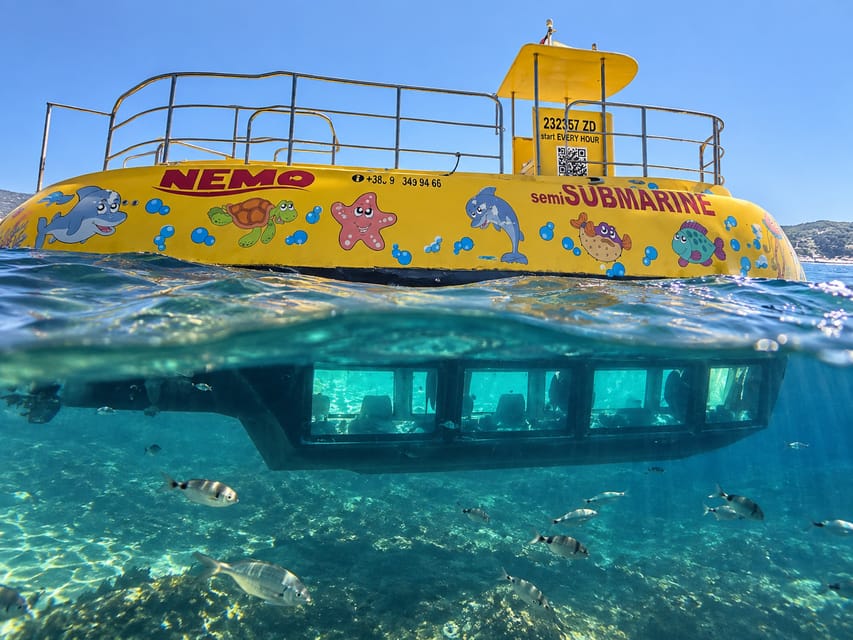 Yellow semi-submarine moored at a harbour quay with the sea behind