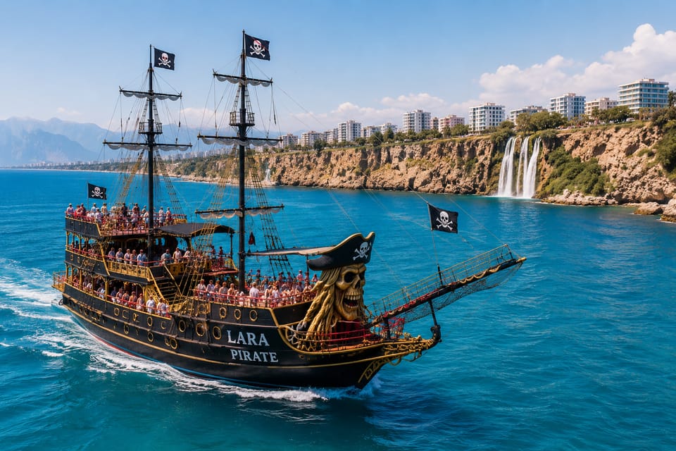 The pirate-style tour boat Lara Pirate off Antalya’s cliffs, with a waterfall dropping into the sea behind