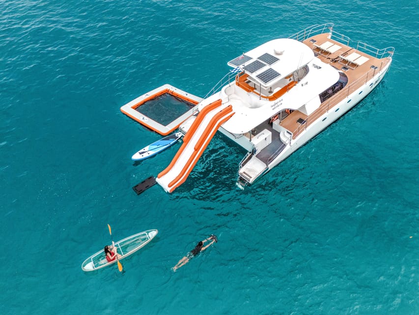 Shallow water off a Coral Island beach near Phuket, with a boat anchored a short way out
