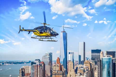 Helicopter over Brooklyn and Manhattan Bridges at dusk