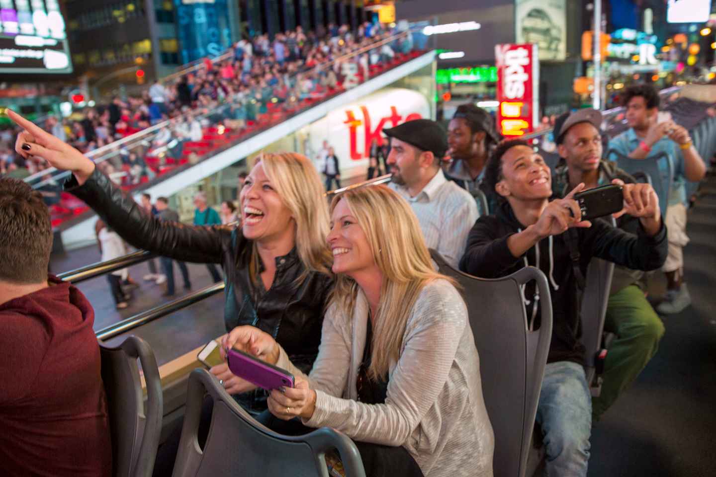 things to do at night in times square | embark on an open-top bus tour
