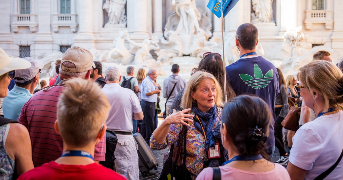 Guide with a walking group in front of Trevi Fountain on a historic-centre tour