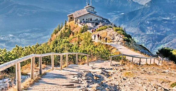 The stone Kehlsteinhaus on its summit ridge above the Berchtesgaden Alps, with the road tunnel entrance below