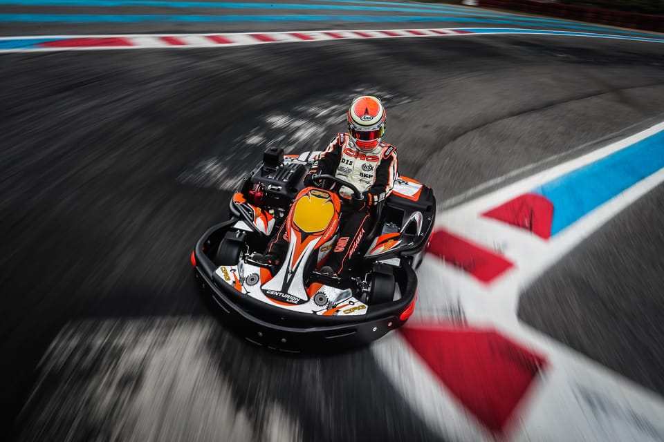 Go-karts lined up in a pit lane ahead of a race