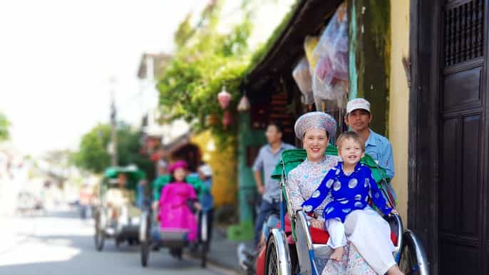 hoi an cyclo tour in vietnamese traditional ao dai