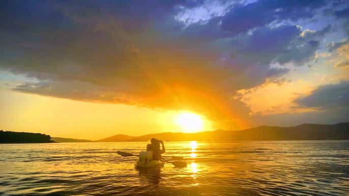 split sea kayaking at sunset