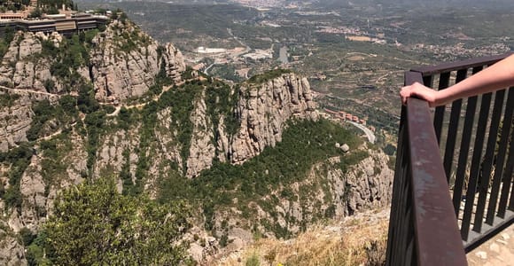 Serrated Montserrat peaks rising behind the monastery buildings