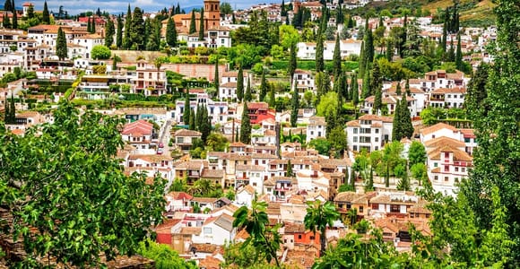 White cave houses and narrow hillside lanes overlooking the Alhambra from Sacromonte