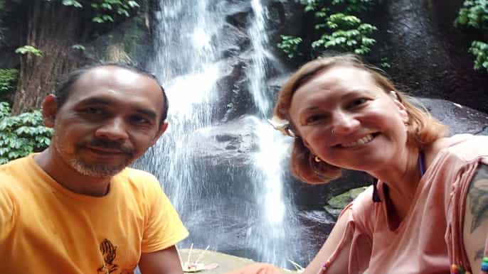 bali meditation yoga at a waterfall with blessing ritual