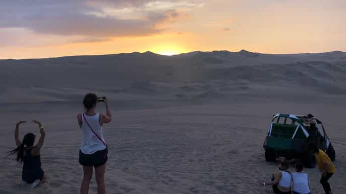 from ica or huacachina dune buggy at sunset sandboarding