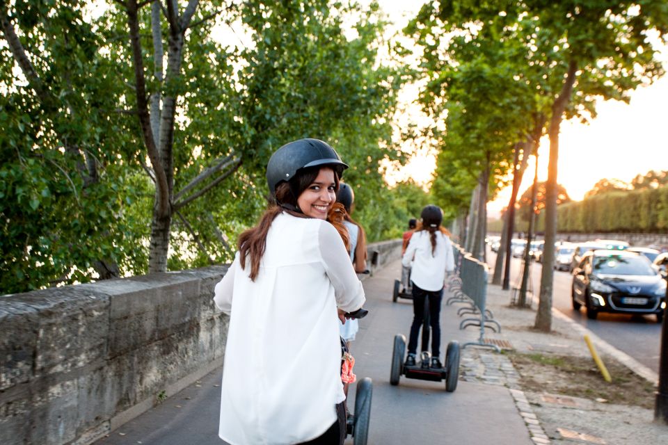 A group of people on Segways, exploring the city of Paris and passing by famous landmarks